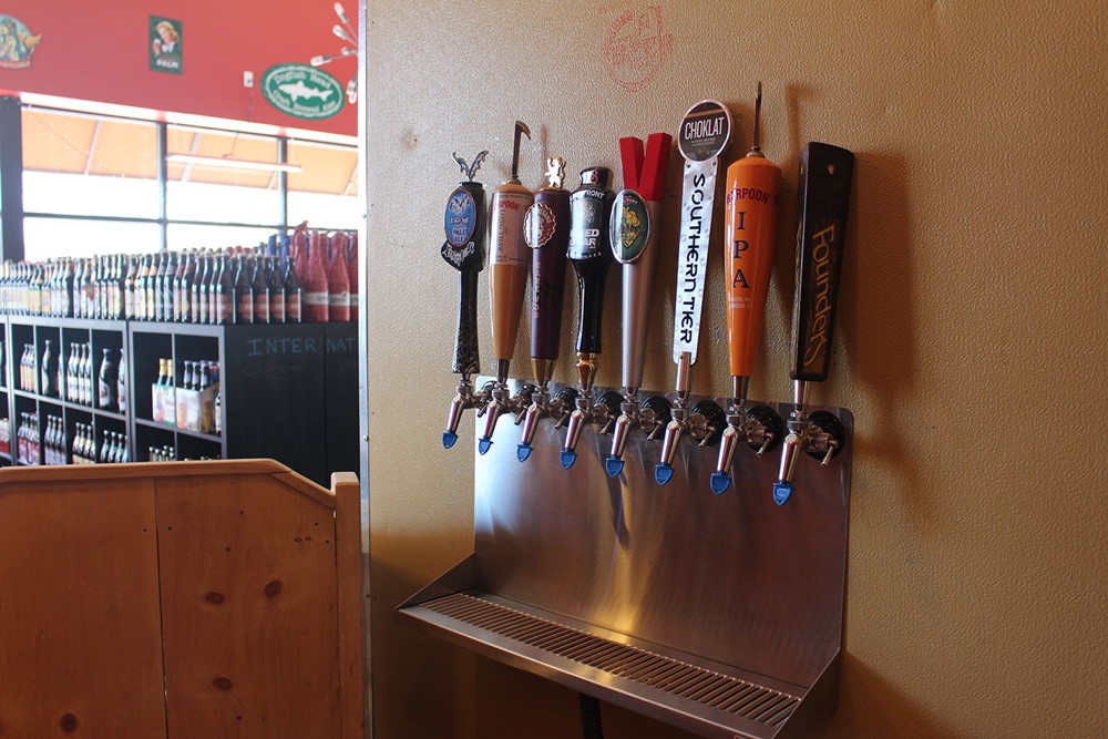 Multiple beer taps offering a variety of brews to choose from, Assorted beer taps with different brews on display.